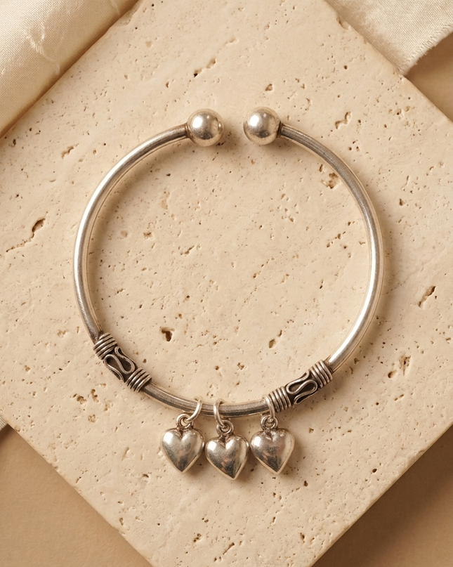 "Silver Oxidized Kada with Heart Charms – Timeless Elegance with a Rustic Touch"